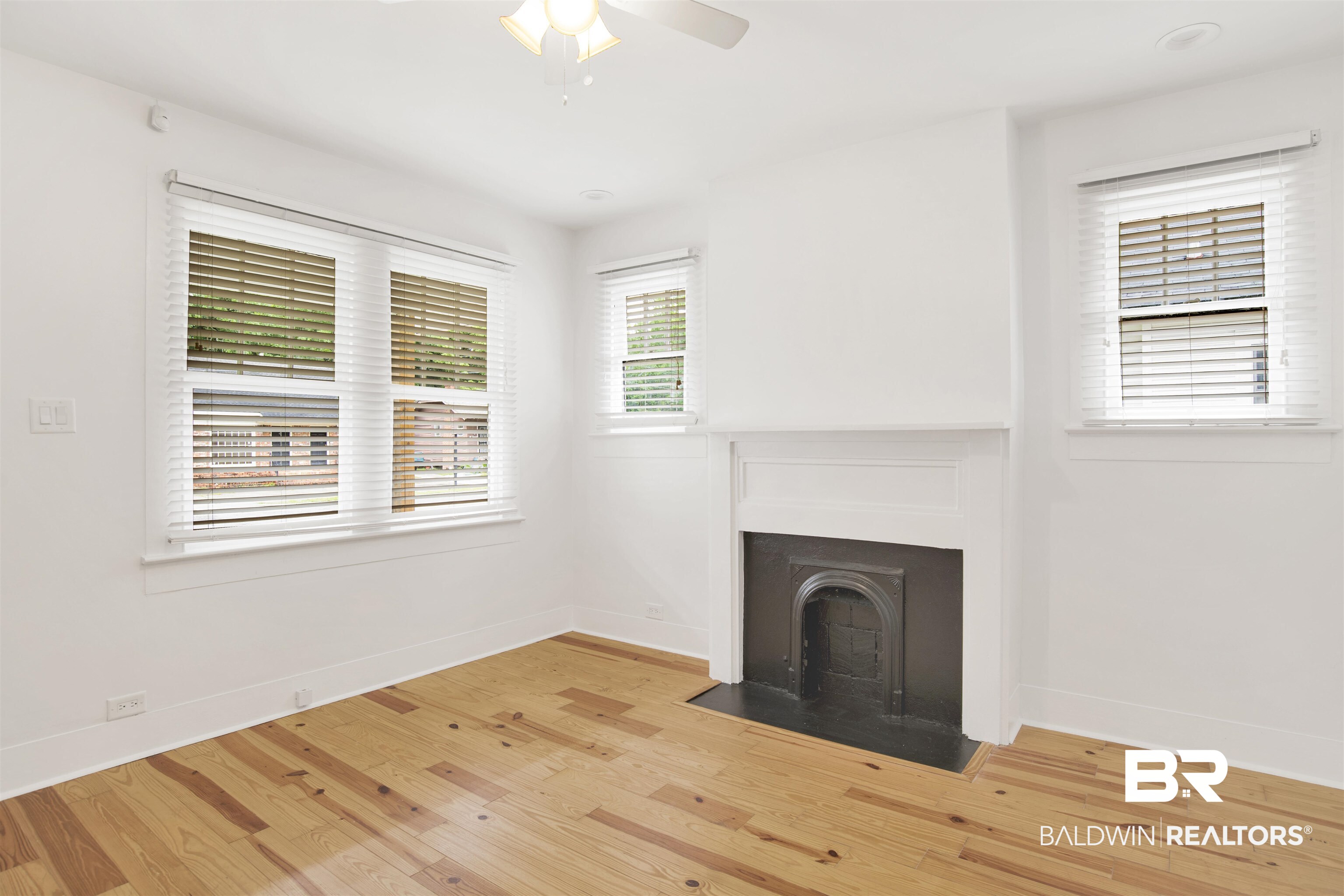 507 Holcombe Avenue Mobile, AL 36606 - Photo 20 of 28 Unfurnished living room with wood finished floors, baseboards, and a fireplace with flush hearth