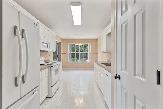 a kitchen with stainless steel appliances a refrigerator sink and cabinets