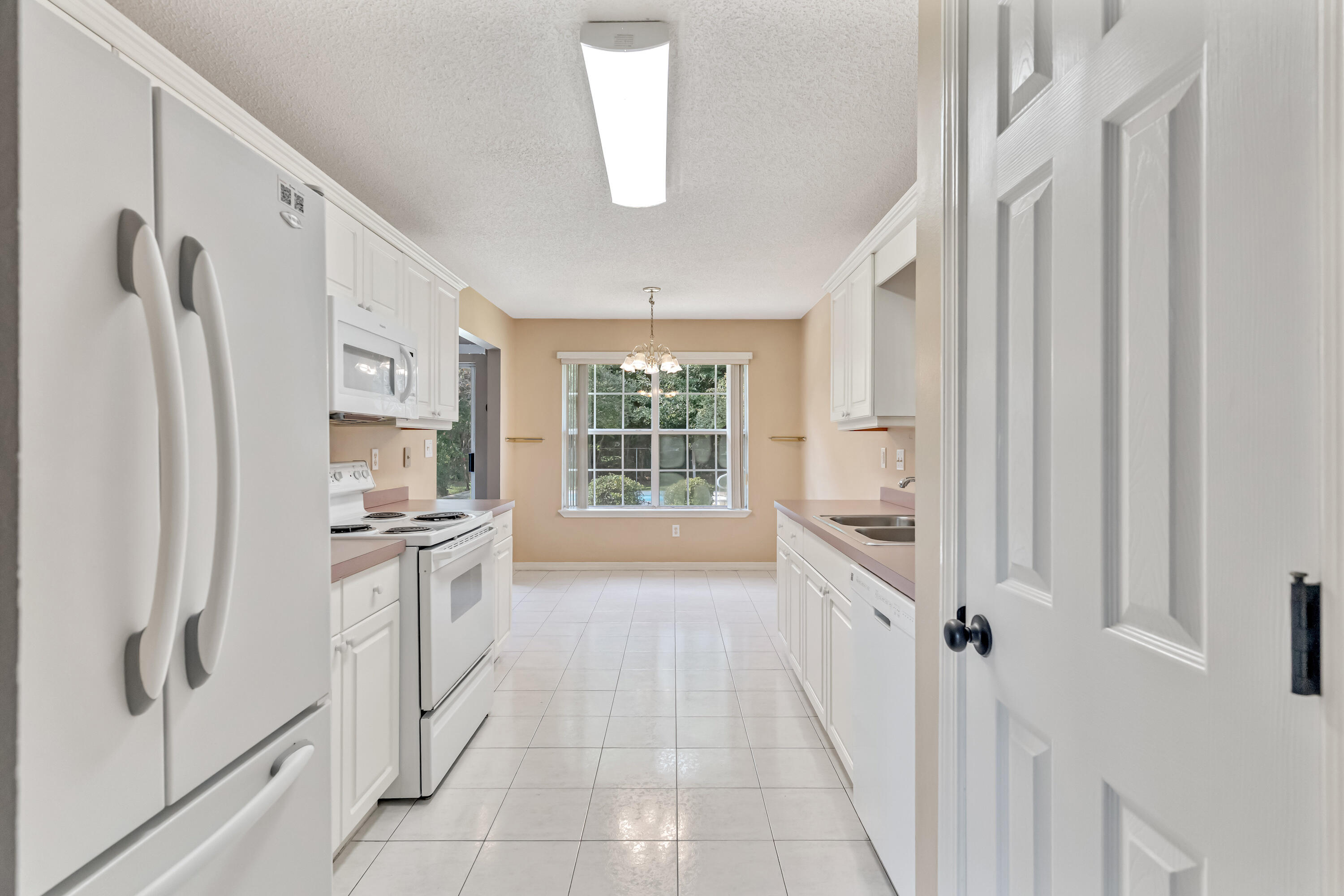1249 Jefferyscot Drive Crestview, FL 32536 - Photo 12 of 40 a kitchen with stainless steel appliances a refrigerator sink and cabinets