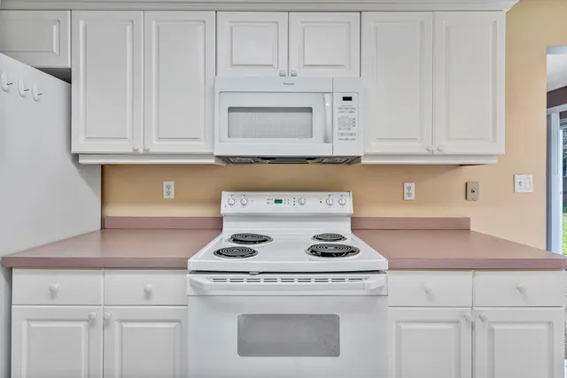 a stove top oven sitting inside of a kitchen