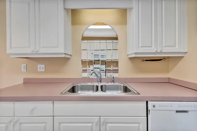 a kitchen with a sink cabinets and a window
