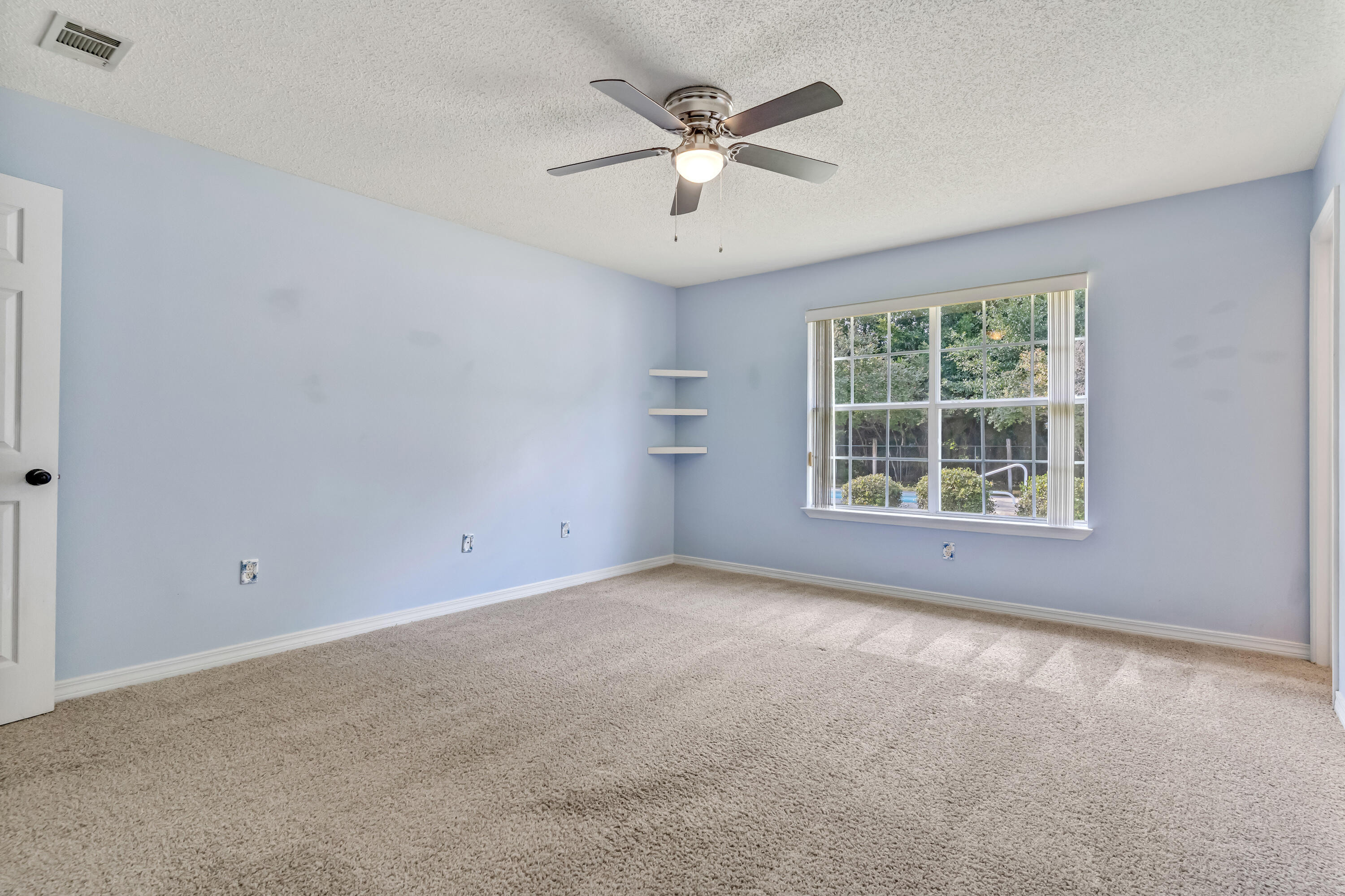 1249 Jefferyscot Drive Crestview, FL 32536 - Photo 20 of 40 an empty room with windows and ceiling fan