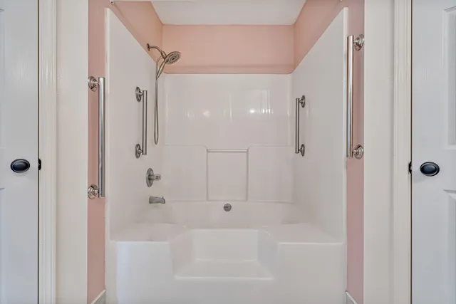 a bathroom with a bathtub and a shower