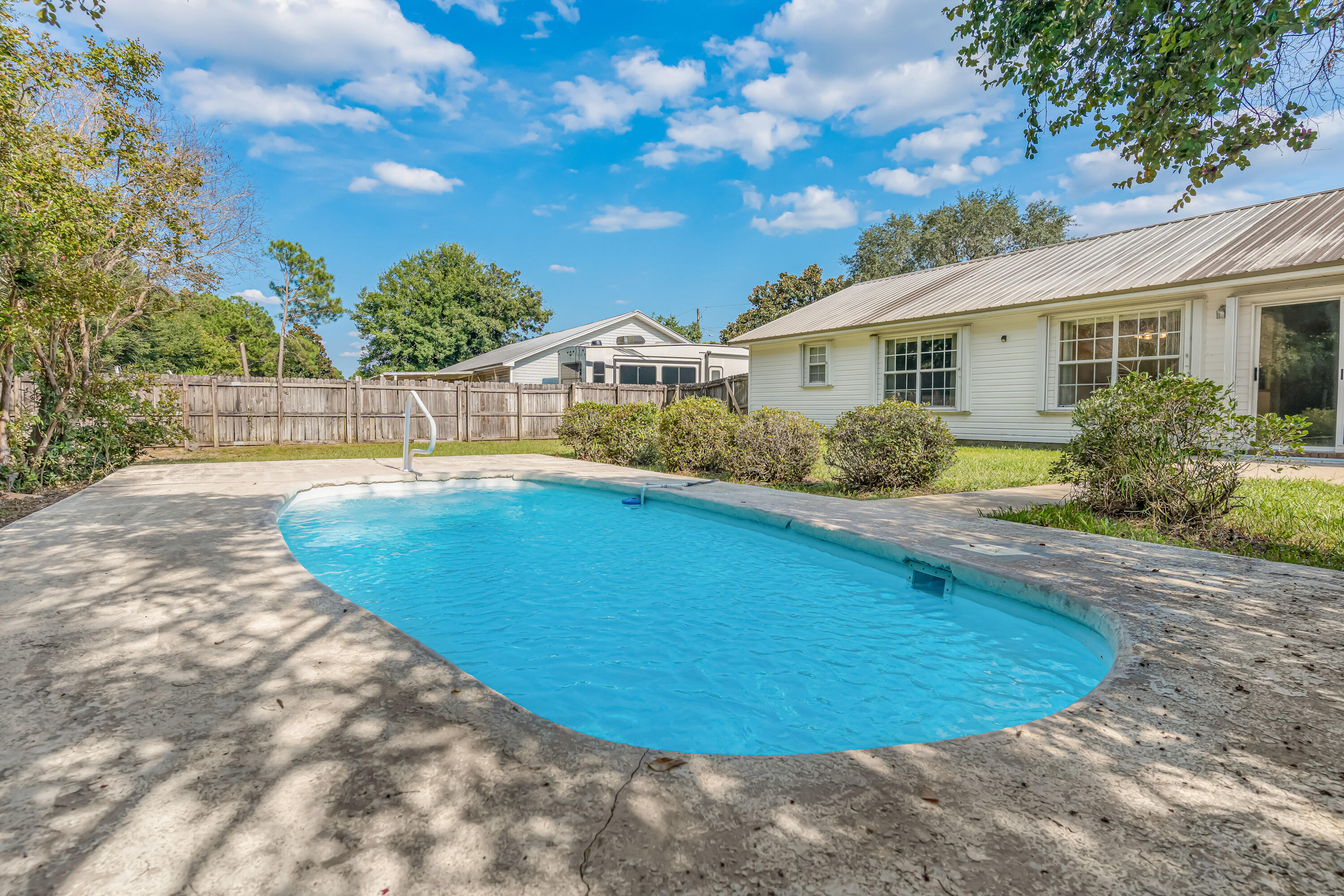 1249 Jefferyscot Drive Crestview, FL 32536 - Photo 33 of 40 a view of a house with swimming pool and a chairs