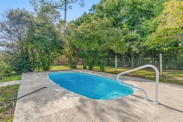 a view of a swimming pool with a yard