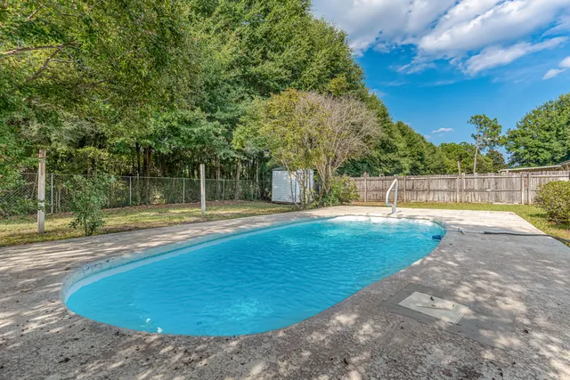 a view of a swimming pool with a yard