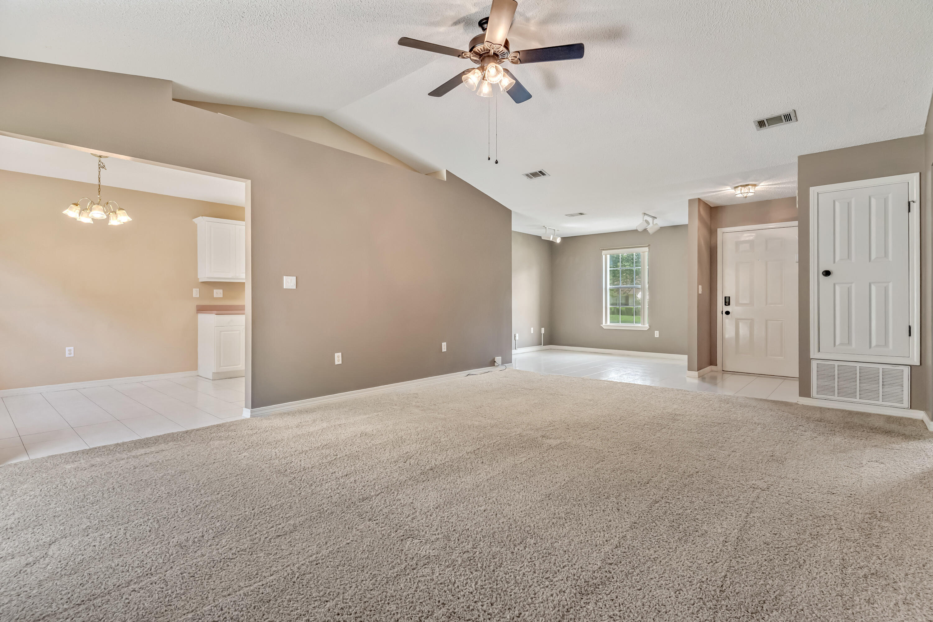 1249 Jefferyscot Drive Crestview, FL 32536 - Photo 9 of 40 a view of a big room with a ceiling fan and entryway