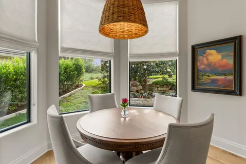 a dining room with furniture and window