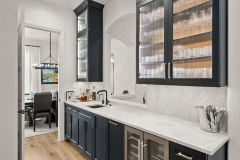 a bathroom with double vanity and two windows