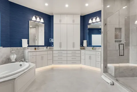 a bathroom with a bathtub sink and mirror