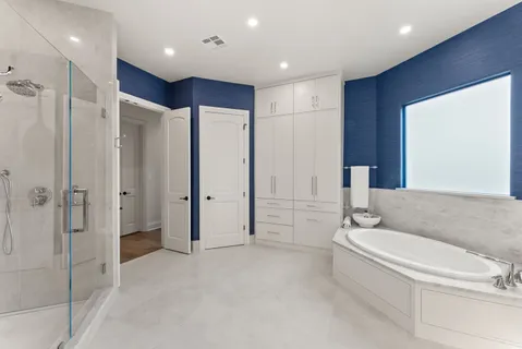 a spacious bathroom with a bathtub and a shower