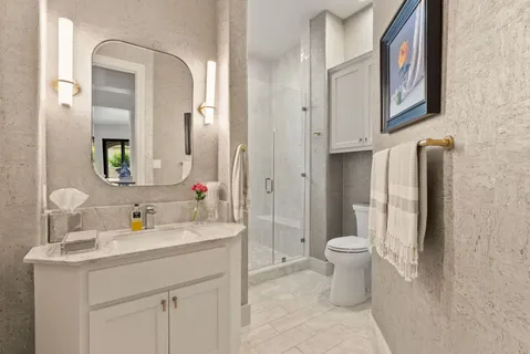 a bathroom with a sink toilet and mirror