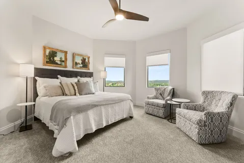 a spacious bedroom with a bed and a couch
