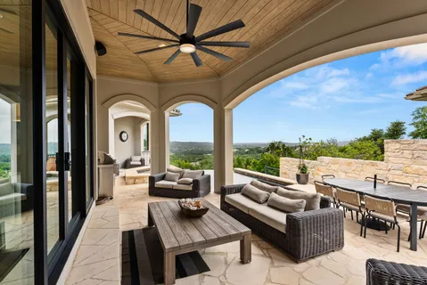 a view of a house with pool and chairs