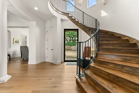 a view of entryway with wooden floor and stairs