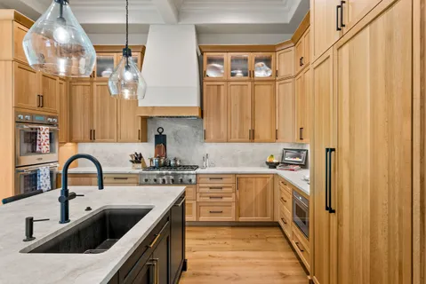 a kitchen with stainless steel appliances a sink and cabinets