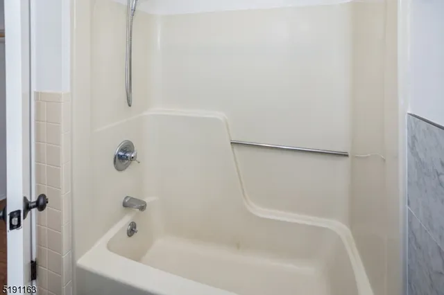 an empty room with wooden floor and closet