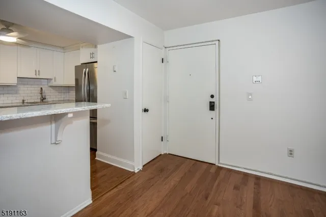 a view of a kitchen with wooden floor