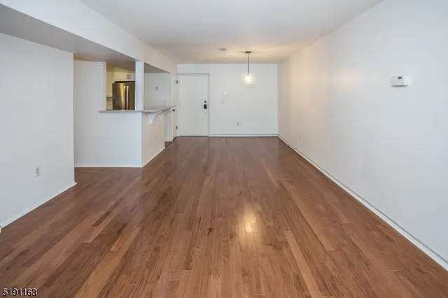 a kitchen with wooden floors and appliances
