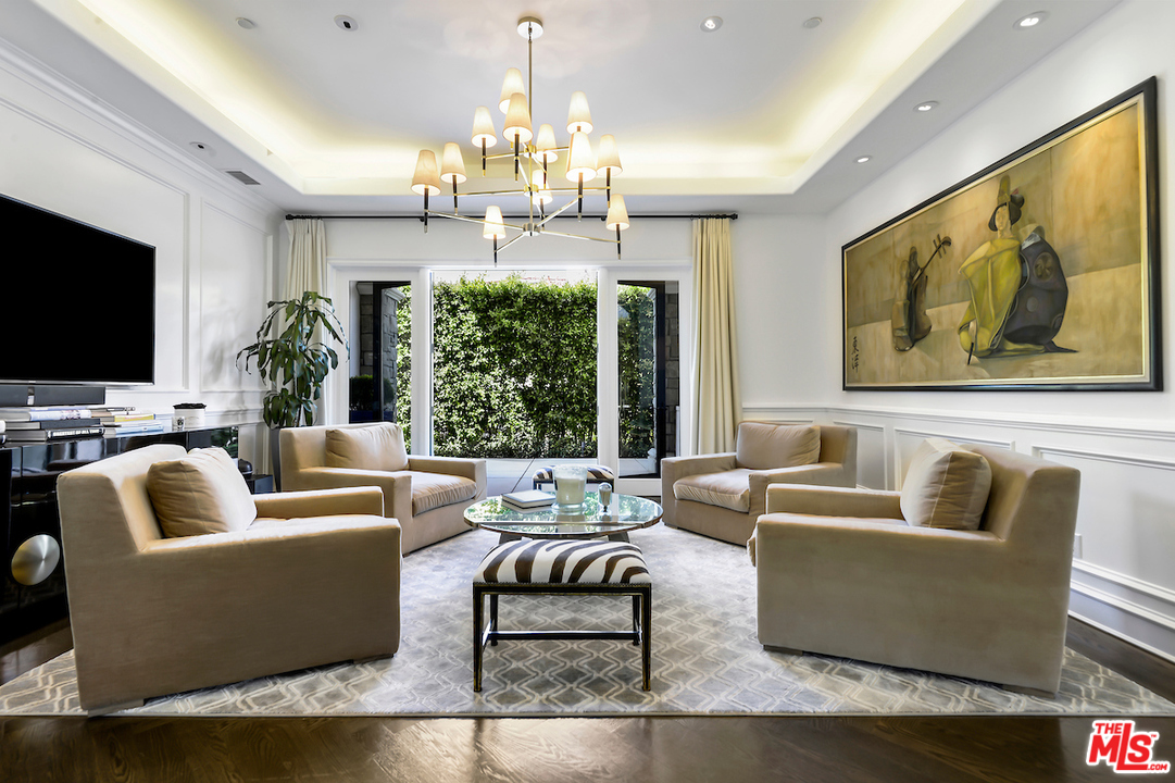 3316 Clerendon Road Beverly Hills, CA 91423 - Photo 12 of 53 a living room with furniture a chandelier and a flat screen tv