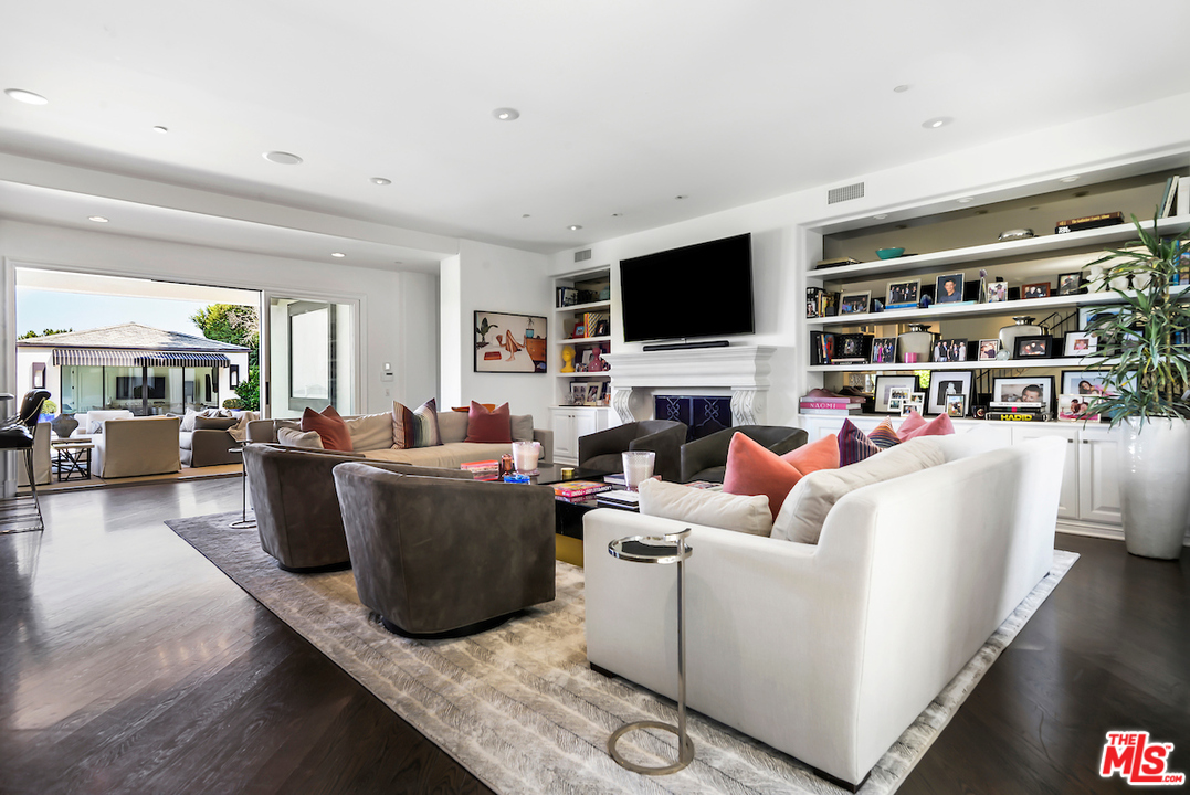 3316 Clerendon Road Beverly Hills, CA 91423 - Photo 13 of 53 a living room with furniture a flat screen tv and a fireplace