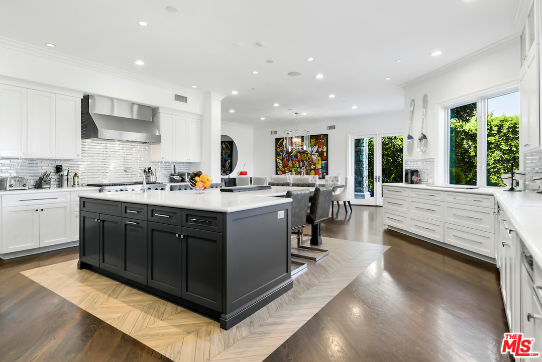 3316 Clerendon Road Beverly Hills, CA 91423 - Photo 16 of 53 a kitchen with stainless steel appliances kitchen island granite countertop a sink counter space cabinets and a large window