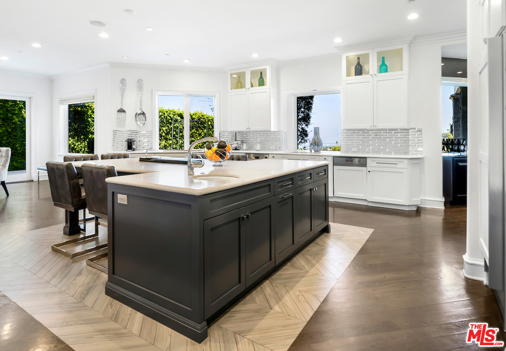 3316 Clerendon Road Beverly Hills, CA 91423 - Photo 17 of 53 a kitchen with a sink a counter top space and stainless steel appliances