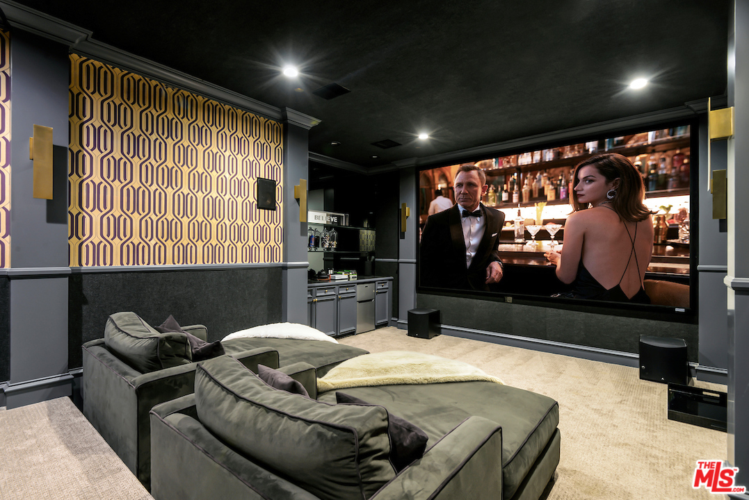 3316 Clerendon Road Beverly Hills, CA 91423 - Photo 30 of 53 a living room with furniture a projector and a flat screen tv