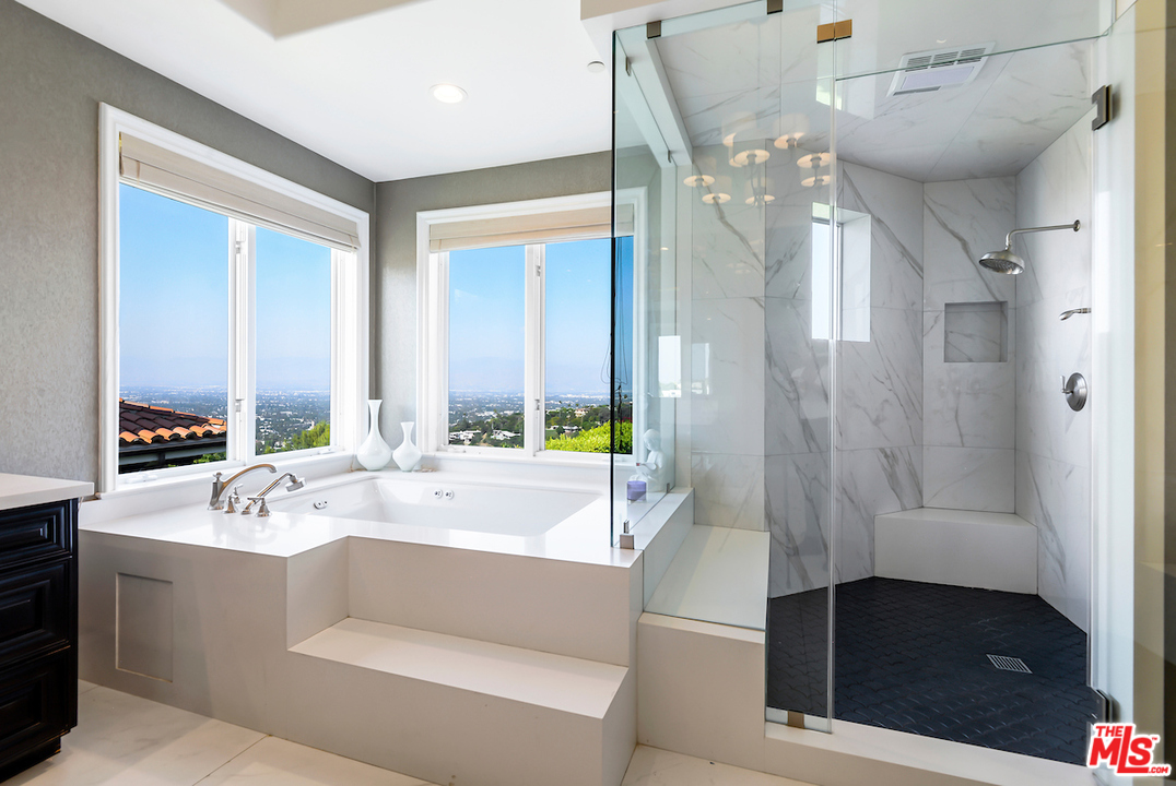 3316 Clerendon Road Beverly Hills, CA 91423 - Photo 44 of 53 a spacious bathroom with a bathtub shower sink and mirror