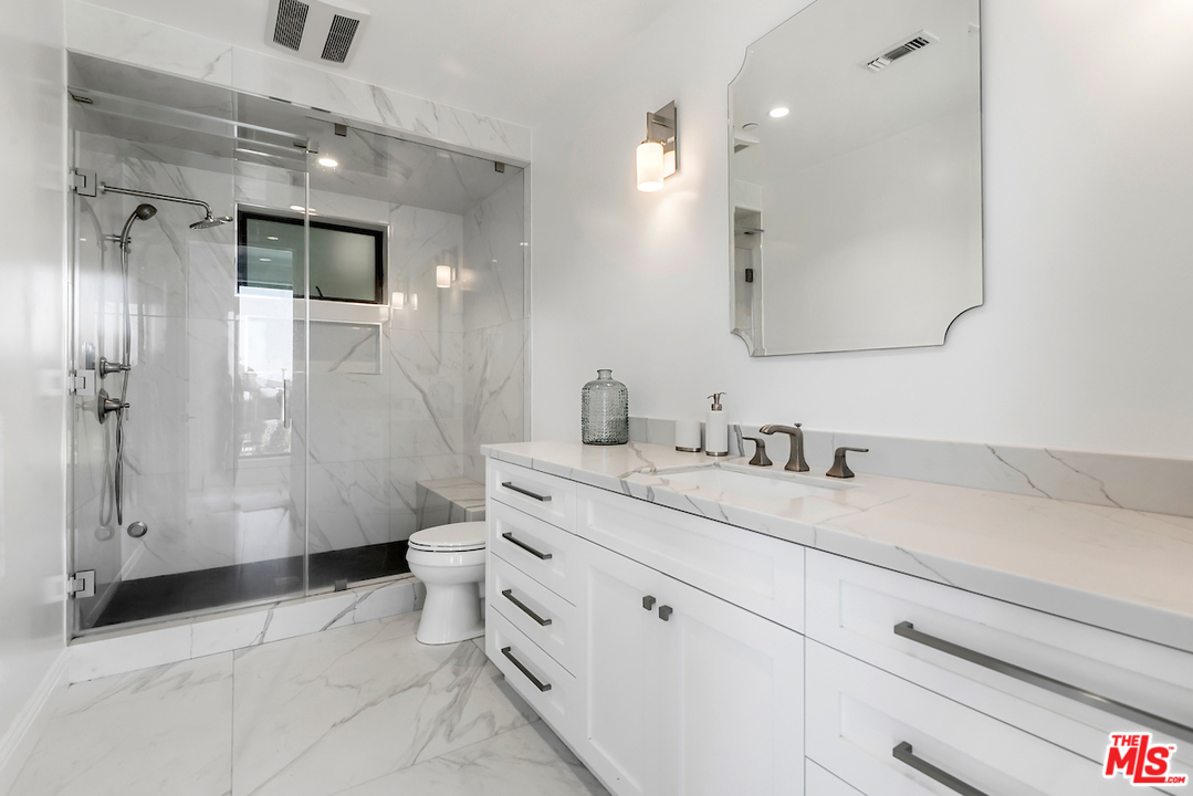 3316 Clerendon Road Beverly Hills, CA 91423 - Photo 52 of 53 a bathroom with a granite countertop sink mirror vanity and toilet