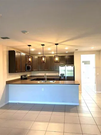 a view of a living room with kitchen