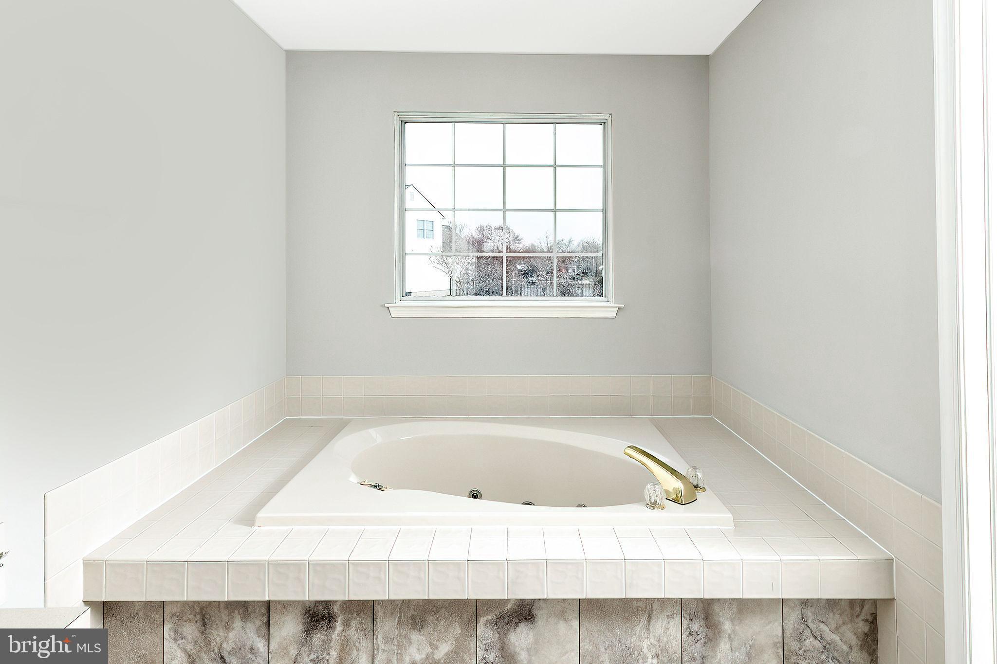 3 Patrick Henry Drive Marlton, NJ 08053 - Photo 34 of 41 a white bath tub sitting in a bathroom next to a window
