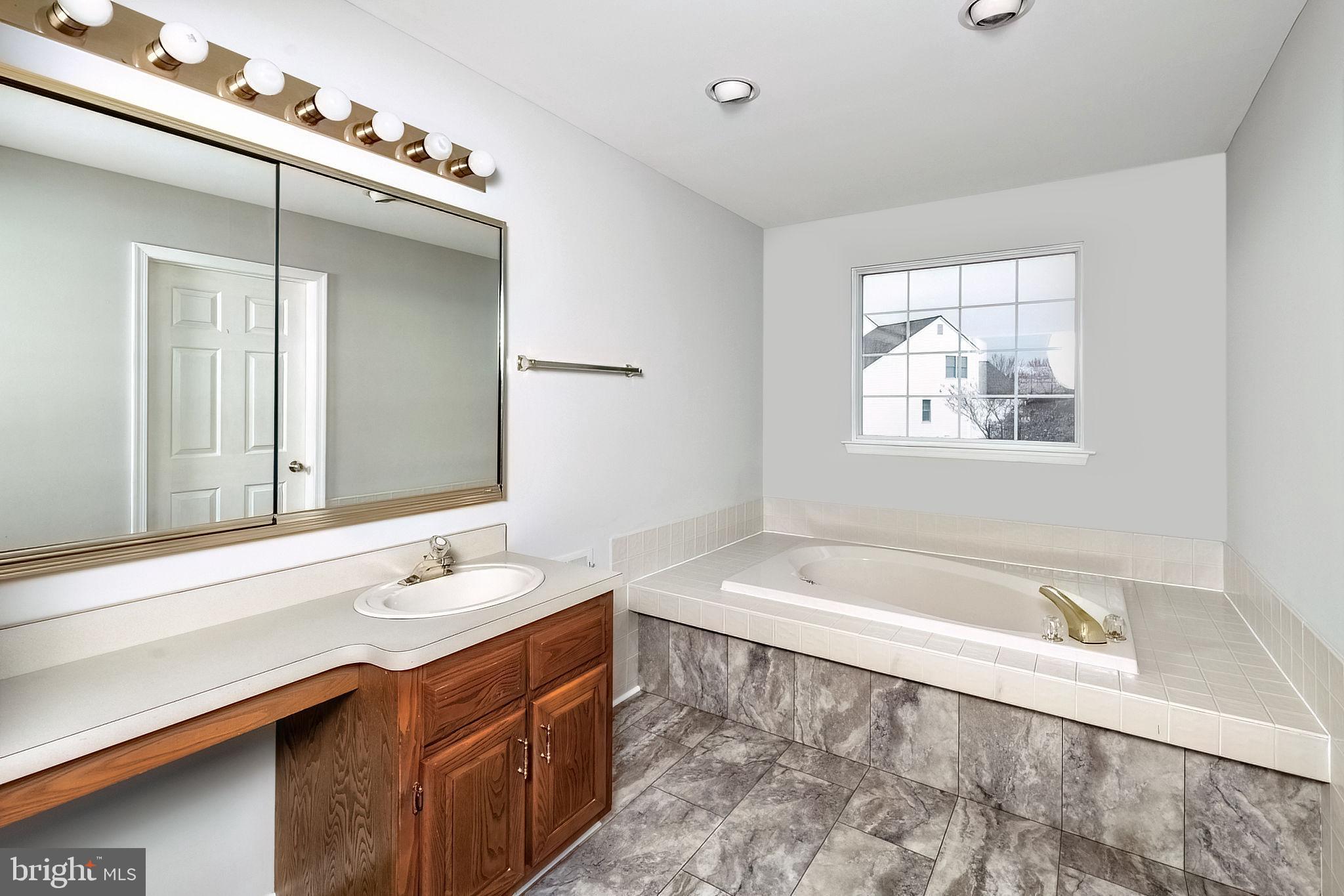 3 Patrick Henry Drive Marlton, NJ 08053 - Photo 38 of 41 a bathroom with a tub a sink and mirror