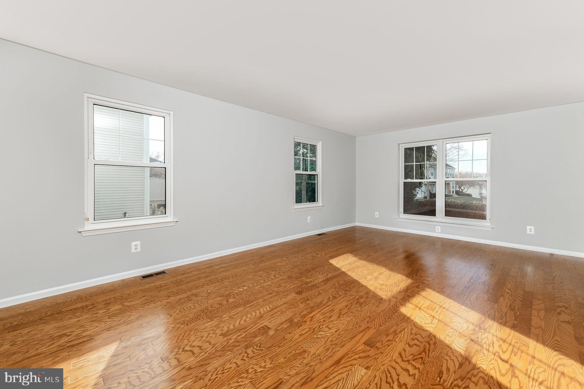3 Patrick Henry Drive Marlton, NJ 08053 - Photo 5 of 41 a view of an empty room with wooden floor and a window