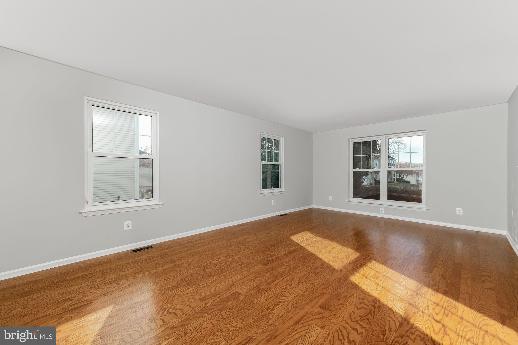3 Patrick Henry Drive Marlton, NJ 08053 - Photo 6 of 41 a view of an empty room with a window and wooden floor
