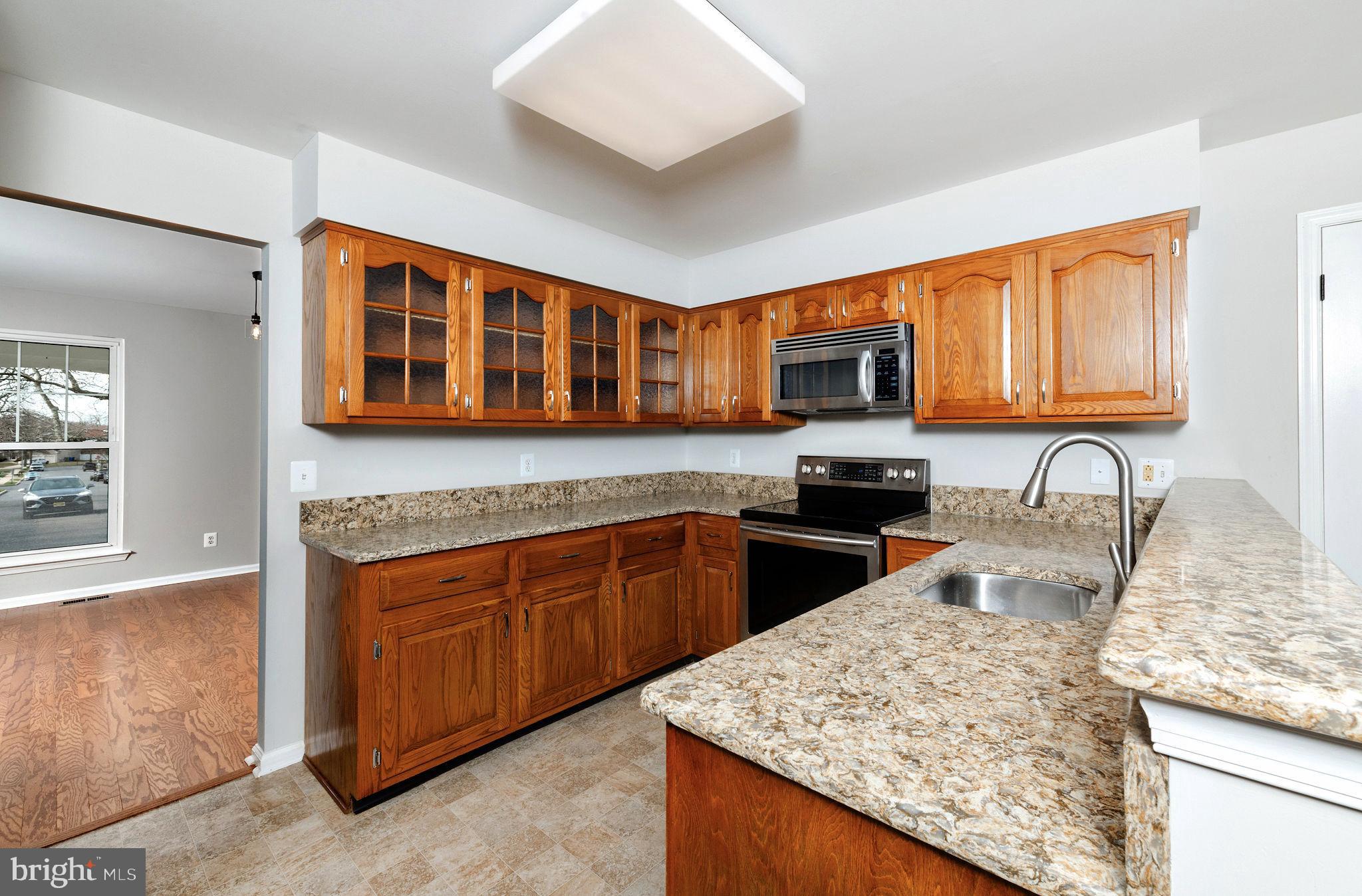 3 Patrick Henry Drive Marlton, NJ 08053 - Photo 8 of 41 a kitchen with granite countertop wooden cabinets and a granite counter tops