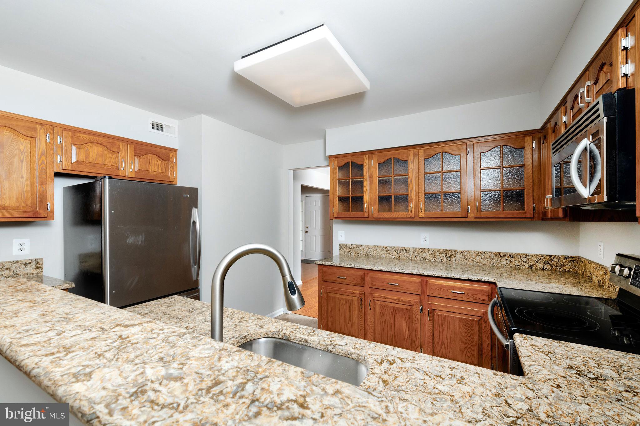 3 Patrick Henry Drive Marlton, NJ 08053 - Photo 10 of 41 a kitchen with stainless steel appliances kitchen island granite countertop a refrigerator and a stove top oven