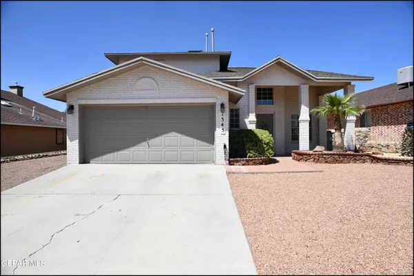 a view of a house with a yard and garage