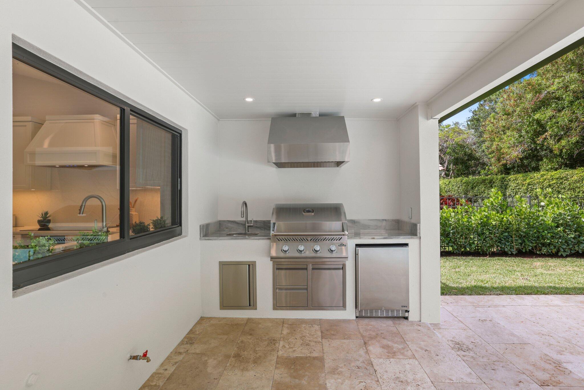 3901 Northwest 27th Avenue Boca Raton, FL 33434 - Photo 48 of 56 a kitchen with stainless steel appliances granite countertop a stove a sink and a microwave