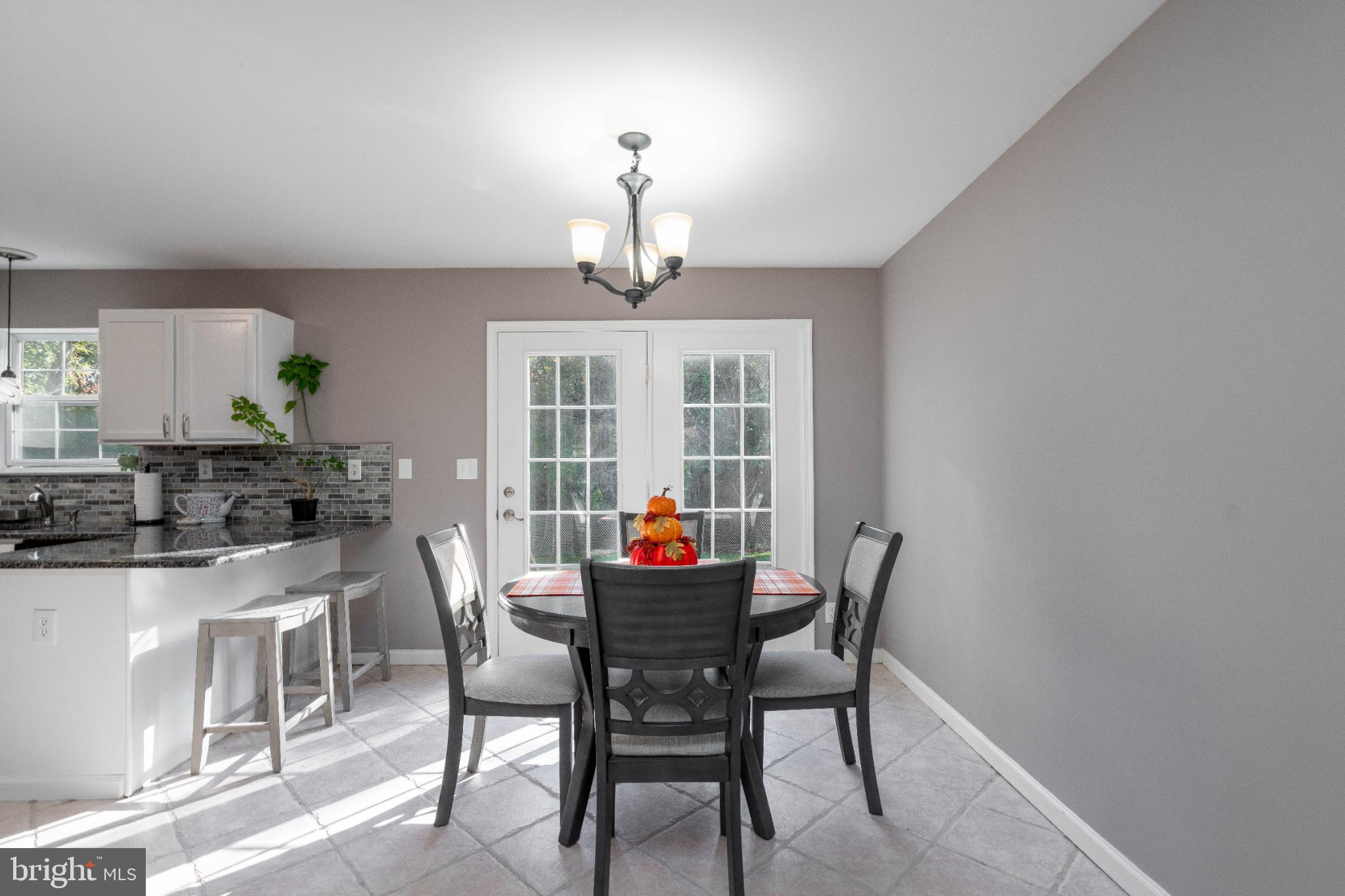 1249 Sassafras Drive Vineland, NJ 08360 - Photo 11 of 34 a dining room with furniture potted plants and wooden floor