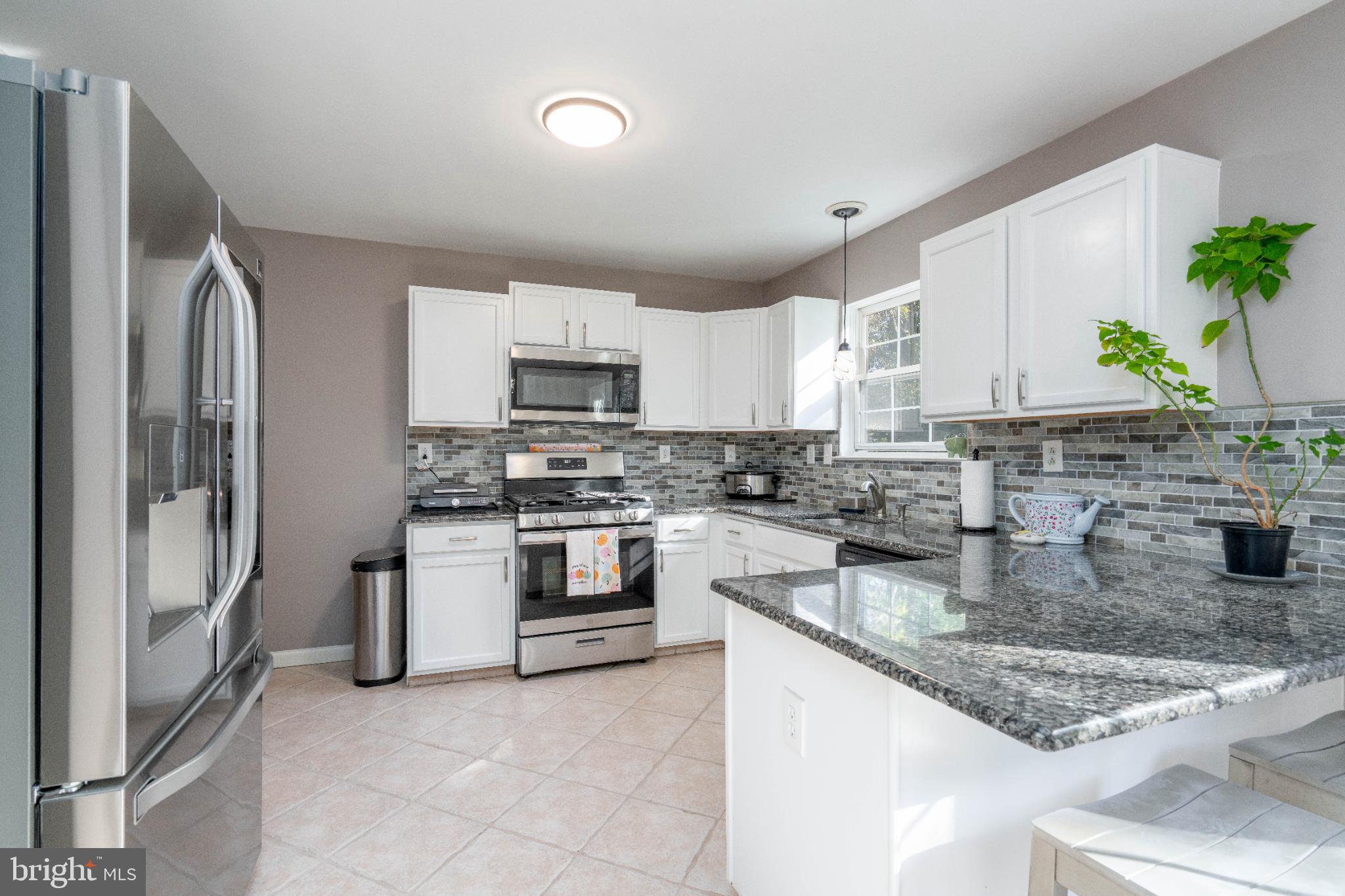 1249 Sassafras Drive Vineland, NJ 08360 - Photo 8 of 34 a kitchen with stainless steel appliances granite countertop a refrigerator sink and stove