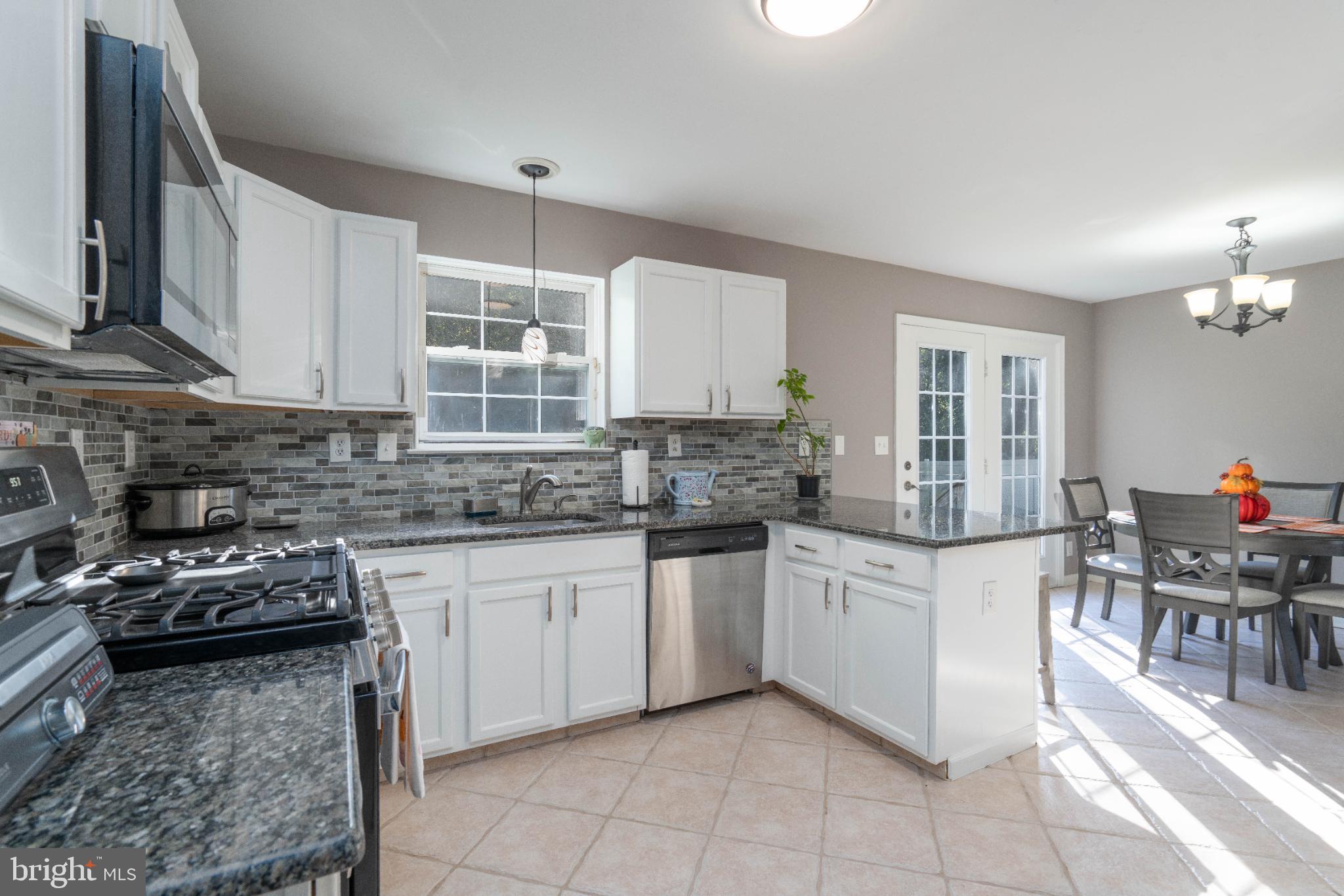 1249 Sassafras Drive Vineland, NJ 08360 - Photo 9 of 34 a kitchen with stainless steel appliances granite countertop a sink stove and cabinets