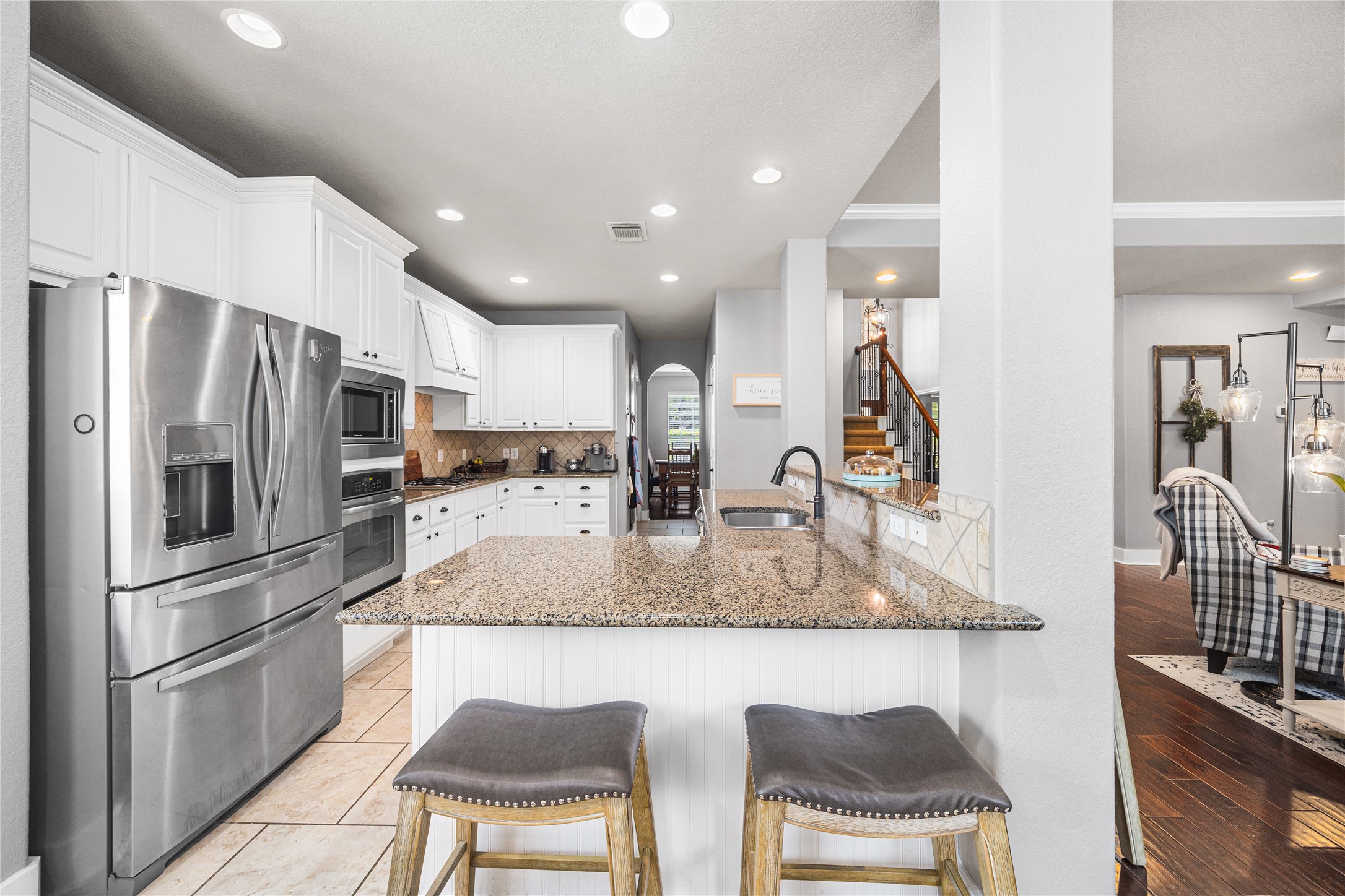 2167 Summit Mist Drive Conroe, TX 77304 - Photo 13 of 34 a kitchen with stainless steel appliances granite countertop a sink refrigerator and cabinets