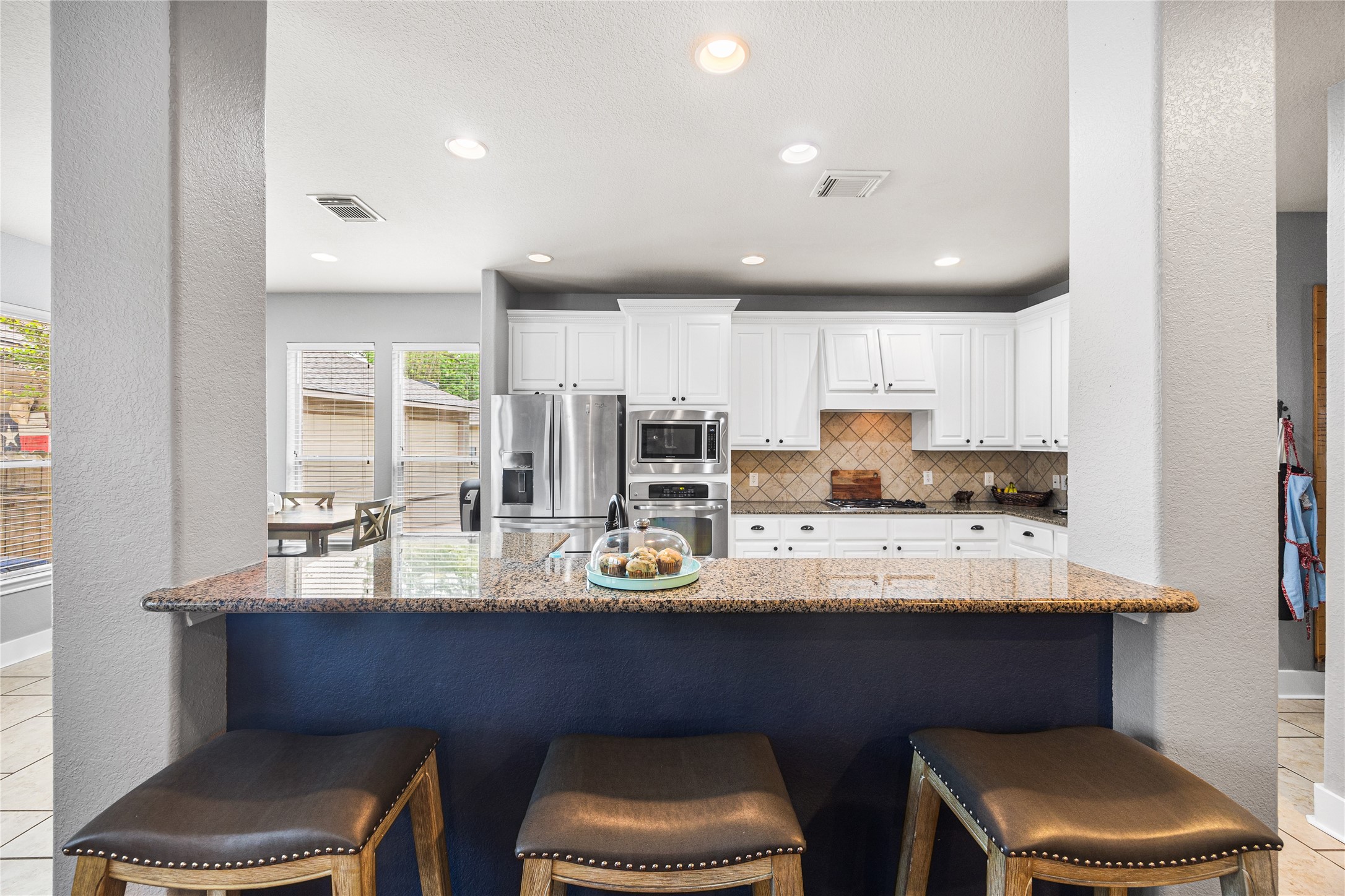 2167 Summit Mist Drive Conroe, TX 77304 - Photo 14 of 34 a kitchen with stainless steel appliances a sink stove and cabinets
