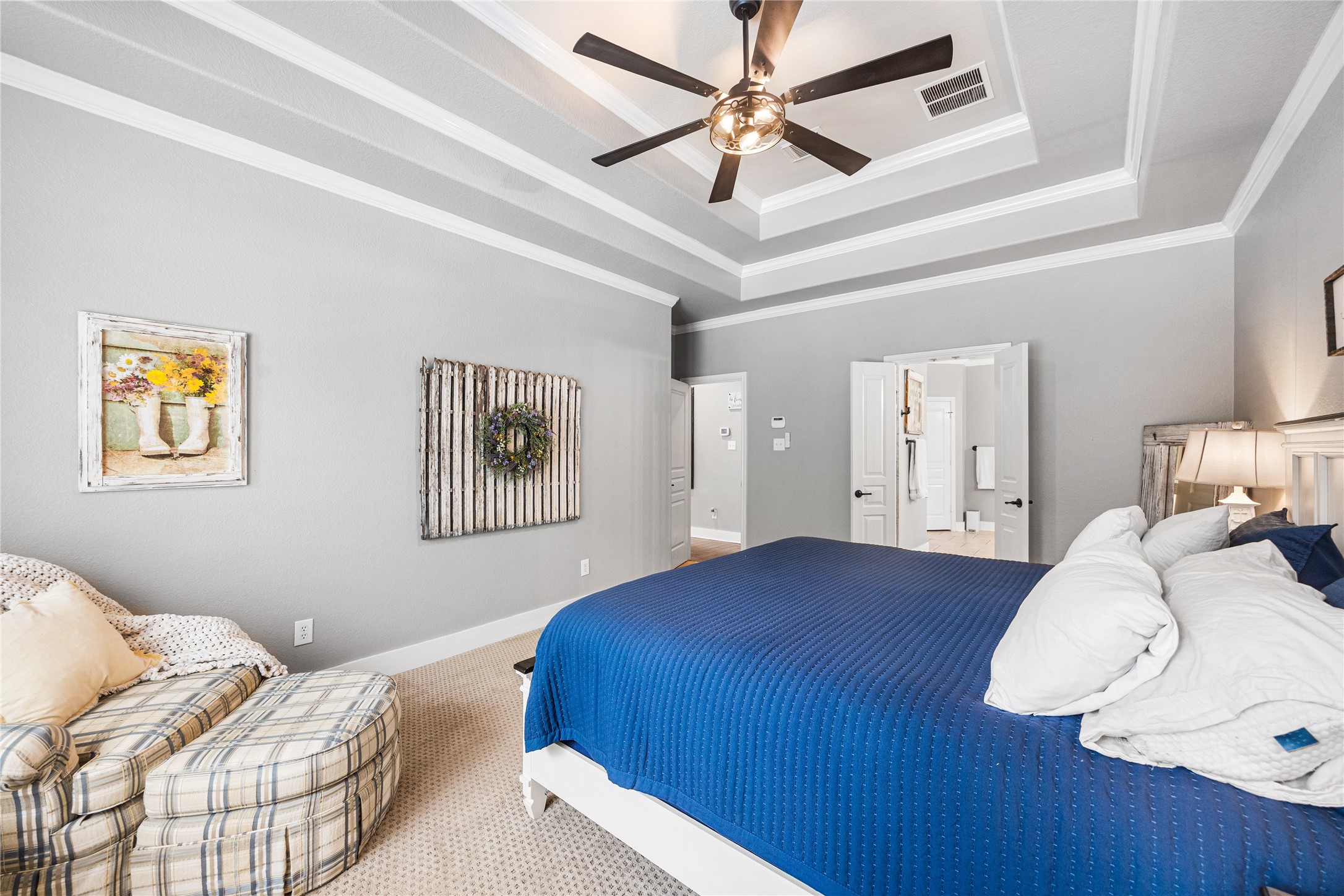 2167 Summit Mist Drive Conroe, TX 77304 - Photo 19 of 34 a bedroom with a large bed and a chandelier