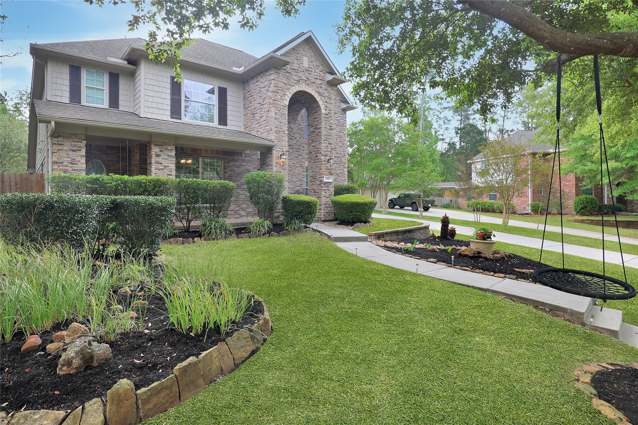 2167 Summit Mist Drive Conroe, TX 77304 - Photo 2 of 34 a front view of a house with a yard table and chairs