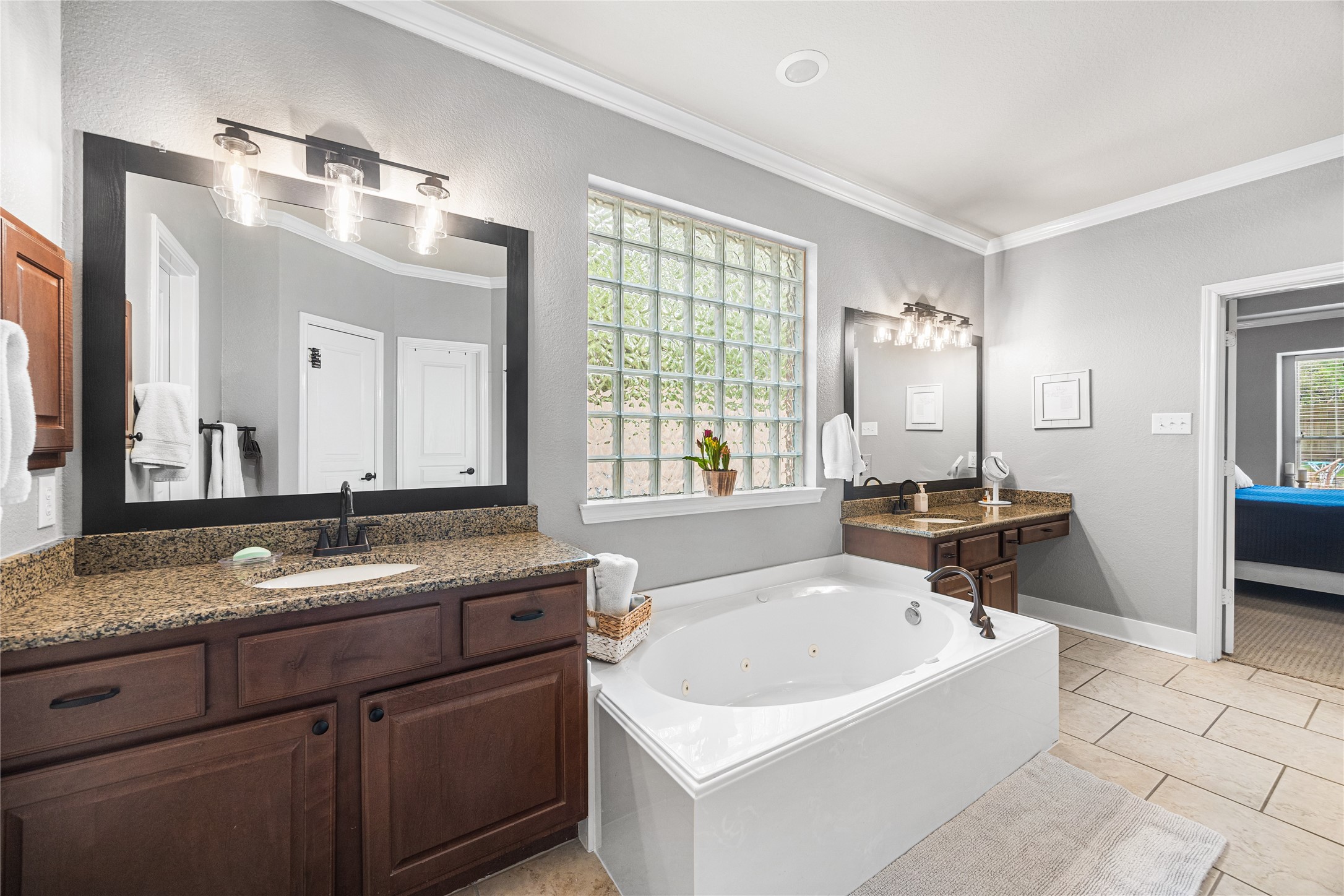 2167 Summit Mist Drive Conroe, TX 77304 - Photo 21 of 34 a bathroom with a granite countertop tub sink and mirror