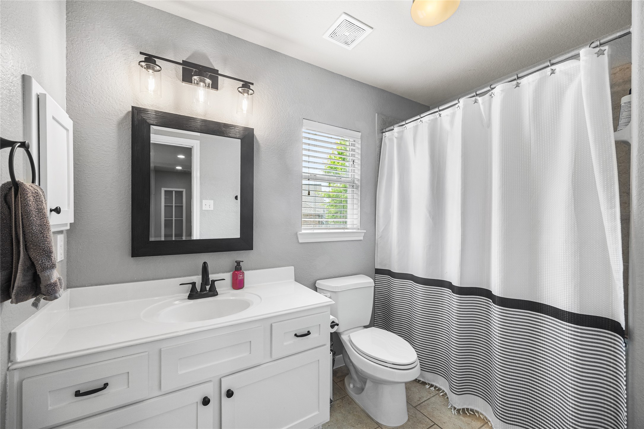 2167 Summit Mist Drive Conroe, TX 77304 - Photo 25 of 34 a bathroom with a sink vanity mirror and toilet