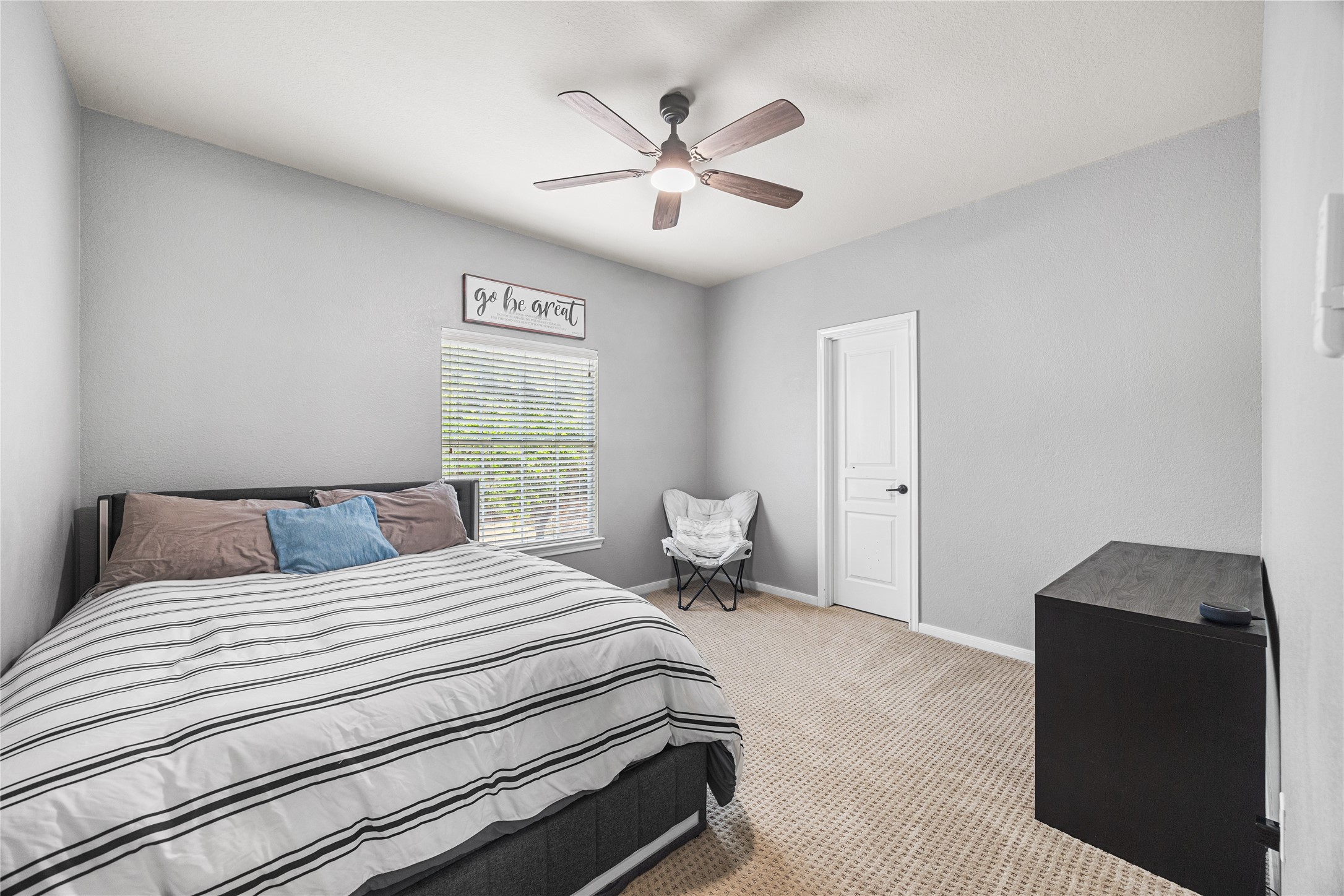 2167 Summit Mist Drive Conroe, TX 77304 - Photo 27 of 34 a bedroom with a bed and a ceiling fan