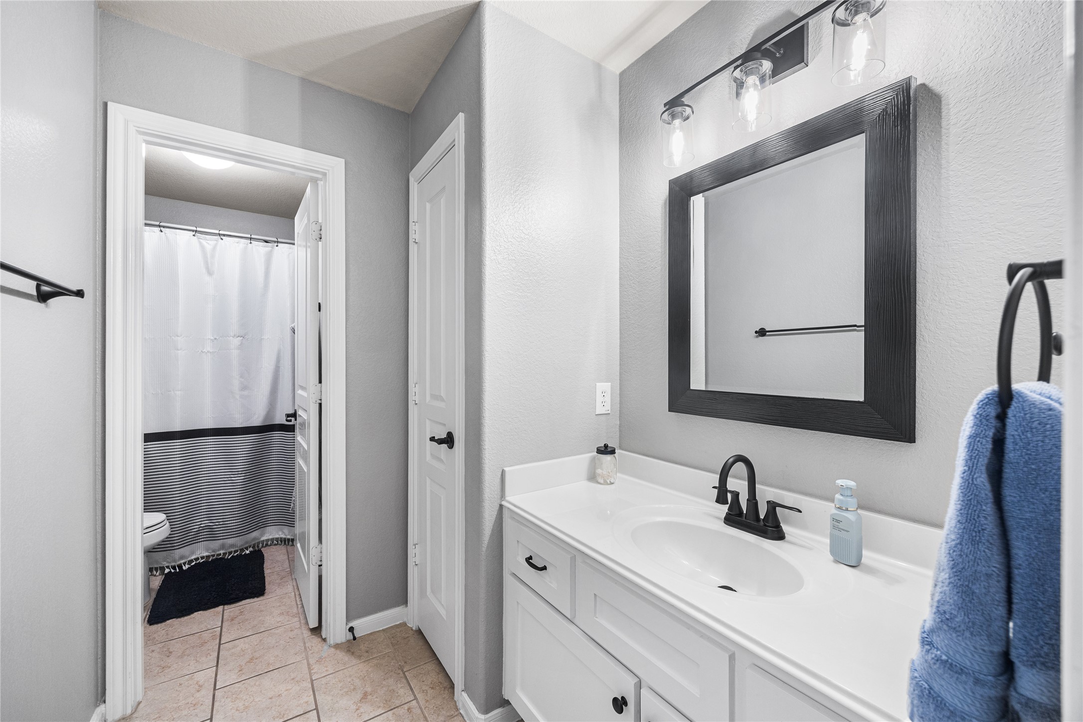 2167 Summit Mist Drive Conroe, TX 77304 - Photo 28 of 34 a bathroom with a sink and a mirror